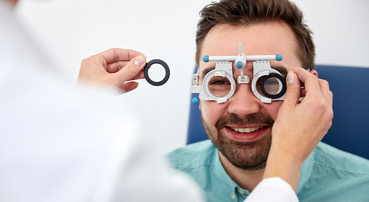 Smiling man having his face fitted for frames